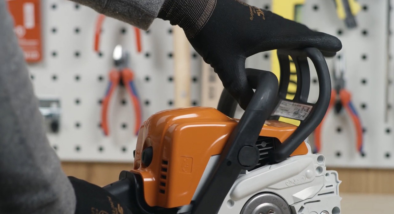 O travão da corrente numa motosserra a bateria STIHL MS 170 a ser libertado